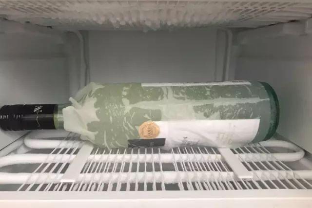Wrap the bottle with a damp cloth and freeze it in the refrigerator